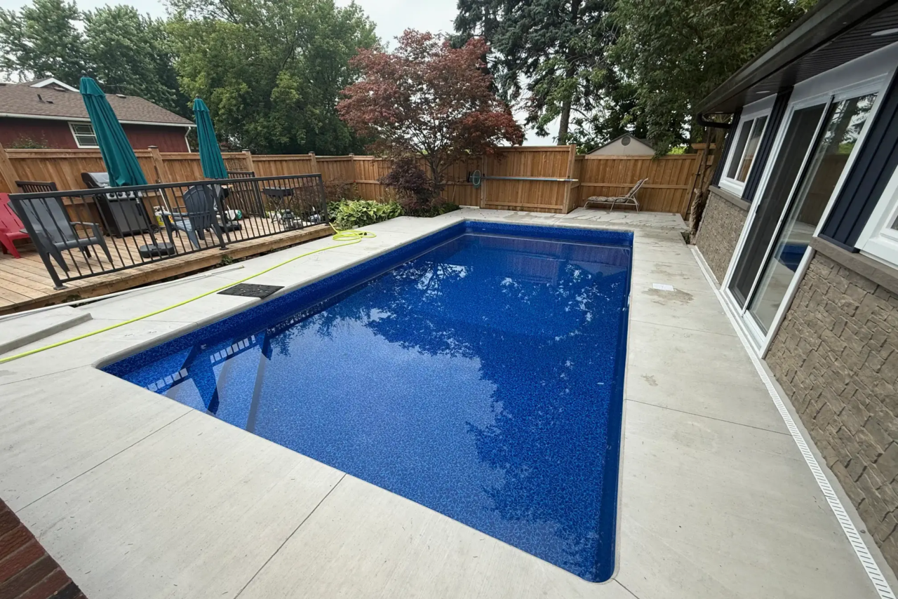New concrete pool deck installed during backyard pool renovation in Niagara